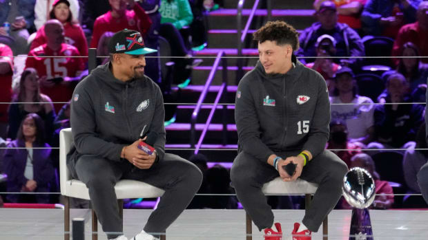 Jalen Hurts and Patrick Mahomes speak on stage during a media event.